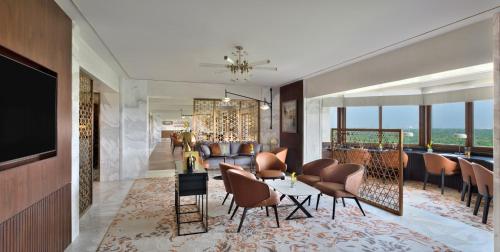 a living room with a table and chairs at Taj Mahal, New Delhi in New Delhi