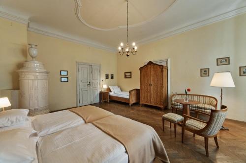 a bedroom with a large bed and a table and a couch at Schloss Drosendorf in Drosendorf Stadt