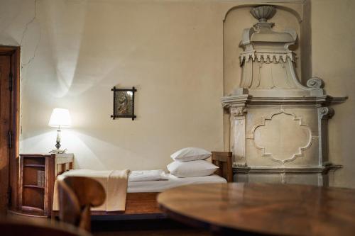 a bedroom with a bed and a table with a lamp at Schloss Drosendorf in Drosendorf Stadt