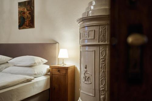a bedroom with a bed and a table with a lamp at Schloss Drosendorf in Drosendorf Stadt