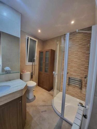 a bathroom with a shower and a toilet and a sink at Roses Casc Antic SL Sant Elm 4 in Roses