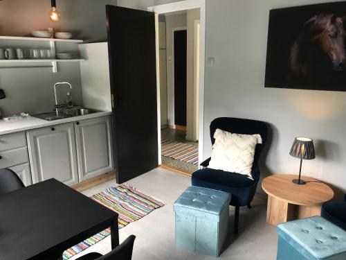 a living room with a chair and a table at Solhaug Fjordcamping in Geiranger