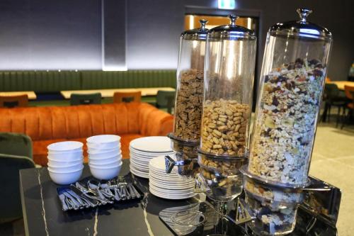 a table with two tall glass containers filled with food at Microtel by Wyndham Wellington in Wellington