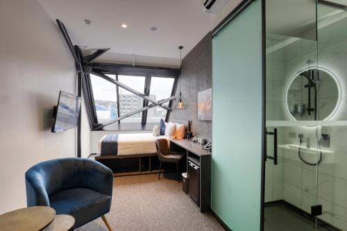 a hotel room with a bed and a bathroom at Microtel by Wyndham Wellington in Wellington