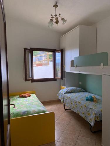 a bedroom with two beds and a window at Villa Grazia in Santa Lucia