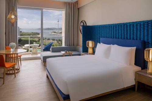 Postel nebo postele na pokoji v ubytování Hyatt Regency Hainan Ocean Paradise Resort