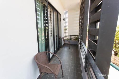a balcony with chairs and windows on a building at Siem Reap Tevi Residence in Siem Reap
