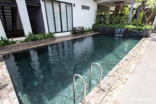 a swimming pool in front of a house at Siem Reap Tevi Residence in Siem Reap