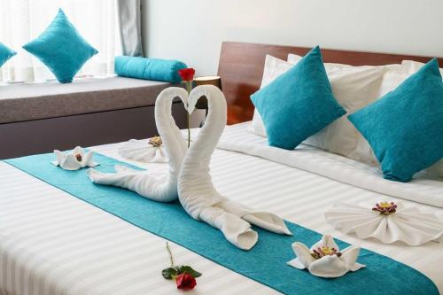 two swans making a heart on a bed at Siem Reap Tevi Residence in Siem Reap