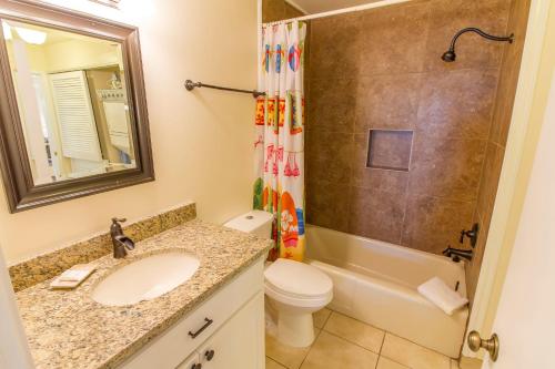a bathroom with a sink and a toilet and a shower at Hibiscus Bravo in St. Augustine