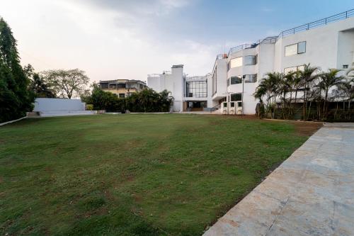 a large grassy yard in front of a building at HOTEL KEWAL in Nashik
