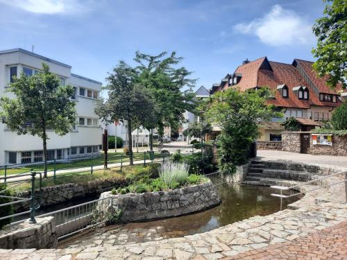 a river in a town with houses and buildings at Ferienwohnung Altstadthaus in Oberkirch