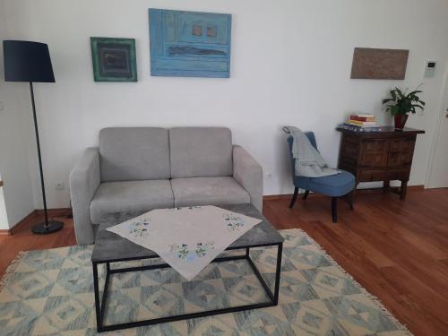 a living room with a couch and a table at Ferienwohnung Altstadthaus in Oberkirch