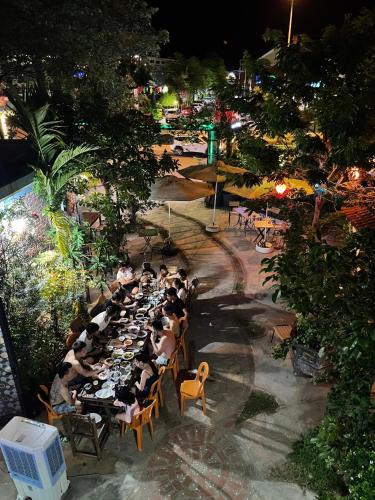 a group of people sitting at a long table at Phong Nha Green Homestay in Phong Nha