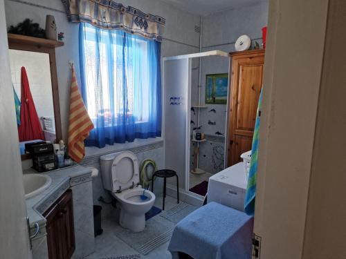 a bathroom with a toilet and a sink and a tub at Single room for one person only 5 Minutes walk to Mellieha Bay Beach in Mellieħa