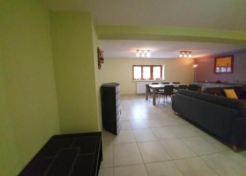 a living room with a couch and a table at Gîte Lilas, LOFT 2 à 8 personnes, avec salle de jeux et SPA dans la résidence in Ventron