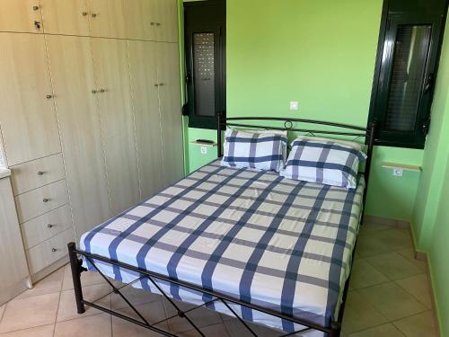 um quarto com uma cama com duas almofadas azuis e brancas em Stunning View Studio in Countryside in Crete em Lerápetra