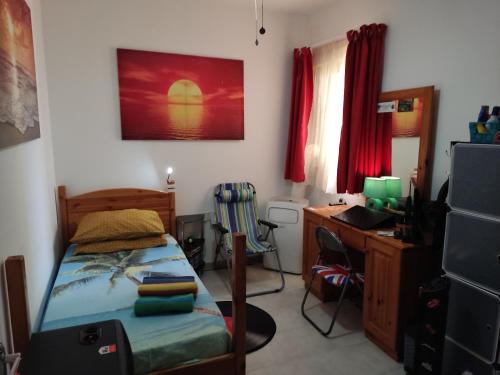 a bedroom with a bed and a desk and a desk at Single room for one person only 5 Minutes walk to Mellieha Bay Beach in Mellieħa