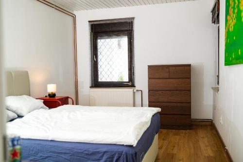 a small bedroom with a bed and a window at The Modern & Comfortable Apartment in Ljubljana