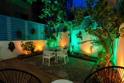 a patio area with a table, chairs, and plants at Şebnem Hotel in Istanbul