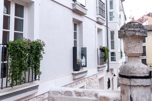 a building with windows and a statue in front of it at HomeSanGil in Burgos