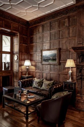 a living room with a couch and a table at Audleys Wood Hotel, Basingstoke in Basingstoke