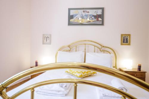a bedroom with a bed with a gold frame at Gold n Blu Petalidi in Petalidhion