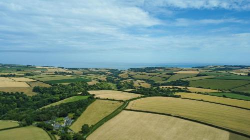 an aerial view of green fields and trees at Furlong Cottage @ Higher Stancombe Farm in Kingsbridge