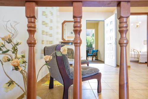 a dining room with a chair and a mirror at Gold n Blu Petalidi in Petalidhion