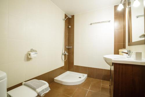 a bathroom with a toilet and a sink at Gold n Blu Petalidi in Petalidhion