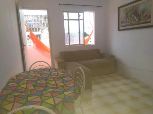a living room with a couch and a table at Temporada Carnaval Praia Olinda e Recife in Paulista