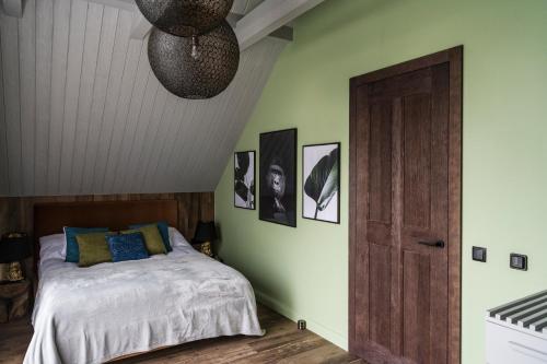 a bedroom with a bed and a ceiling at Aqua Your Stay in Sasino
