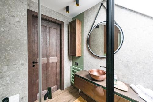 a bathroom with a sink and a mirror at Aqua Your Stay in Sasino