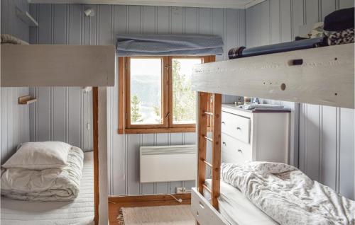 a bedroom with two bunk beds and a window at Amazing Home In Fagernes With 2 Bedrooms in Fagernes