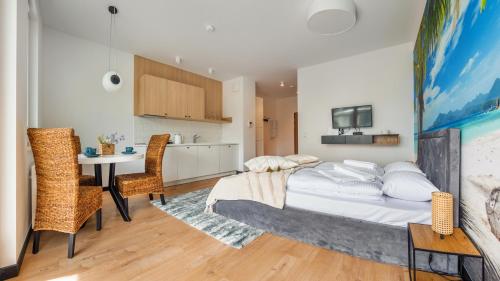 a bedroom with a bed and a table and chairs at Nexo, Sun & Snow in Puck