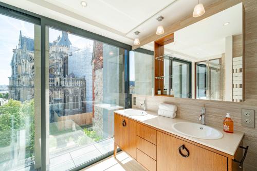 a bathroom with a sink and a large window at Les 7 Anges - Cathédrale de Reims in Reims