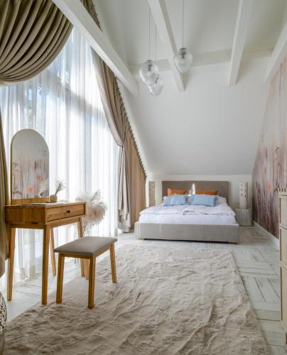 a bedroom with a bed and a table and a desk at Aqua Your Stay in Sasino