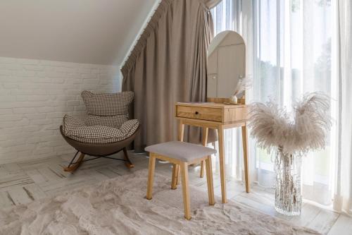 a dressing room with a desk and a chair and a mirror at Aqua Your Stay in Sasino