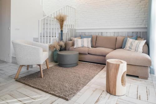 a living room with a couch and a table at Aqua Your Stay in Sasino