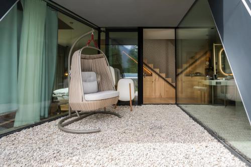 a chair sitting on a rug in a room at Olympic SPA Hotel - Adults Only in Vigo di Fassa
