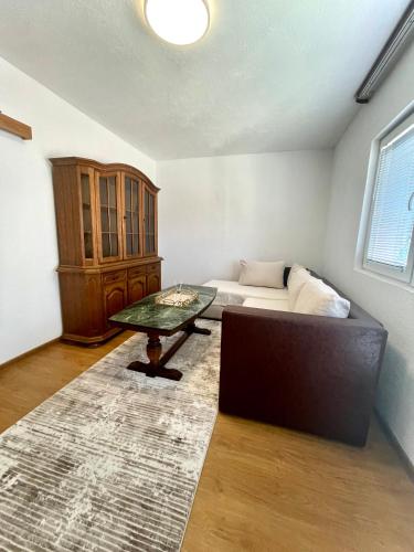 a living room with a couch and a table at Apartment SunLight in Visoko