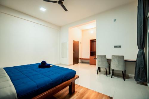 a person laying on a blue bed in a room at Commune18 Resort Chikmagalur in Chikmagalūr