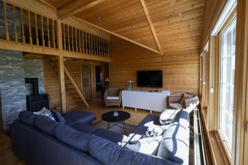 a living room with a couch and a table at Golden Circle Vacation Home with hot tub & fire place in Selfoss
