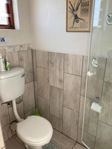 a bathroom with a toilet and a shower at Waves Of Witsand in Witsand