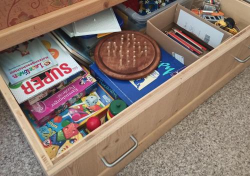 a drawers filled with toys and a cookie at Ferienwohnung Zillertaler Alpenblick in Zell am Ziller