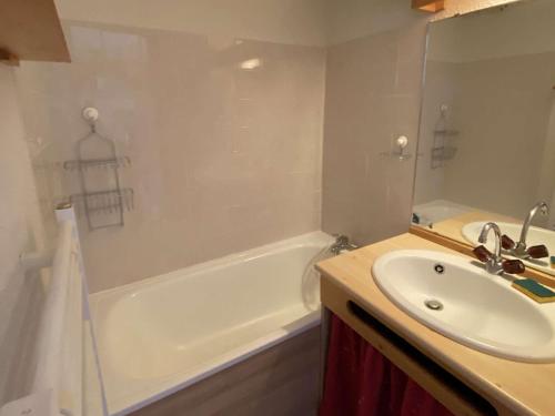 a bathroom with a sink and a bath tub and a sink at Appartement Arêches-Beaufort, 2 pièces, 4 personnes - FR-1-342-154 in Arêches-Beaufort