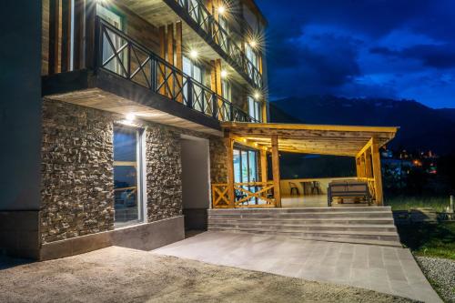 a house with a porch at night at Hotel Latveli Mestia in Mestia