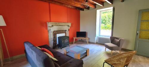 - un salon avec un canapé et une cheminée dans l'établissement Joli gîte chez Paulette à 10 min du Puy du Fou, à Sevremont