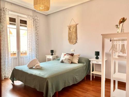 a bedroom with a bed and a window at Housing León Catedral in León