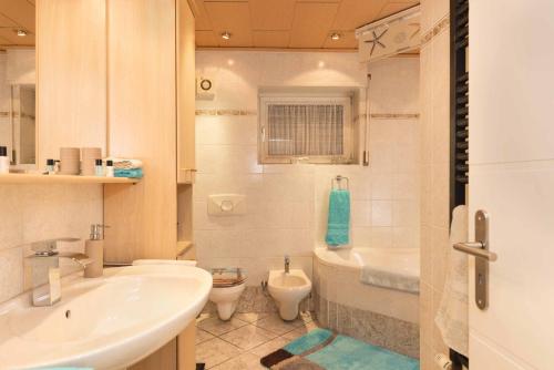 a bathroom with a sink and a toilet at Ferienwohnung Schwallmann in Wilnsdorf